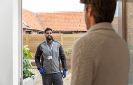 eon employee chatting to member of public at their door.