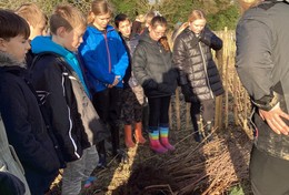 Pupils and officer looking at tree whips