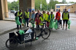 team of litterpickers with bags and equipment with a bike in the foreground 