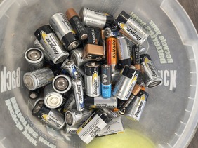 Picture of dry cell batteries various sizes in a tub
