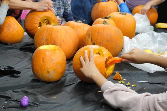 Pumpkins on a table being carved