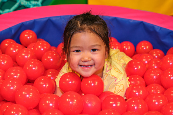 Child in ball pit.