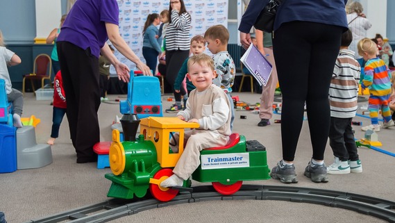 A child on a ride-on train. 