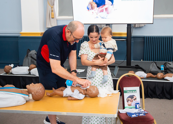 Parent/carer taking part in first aid training. 