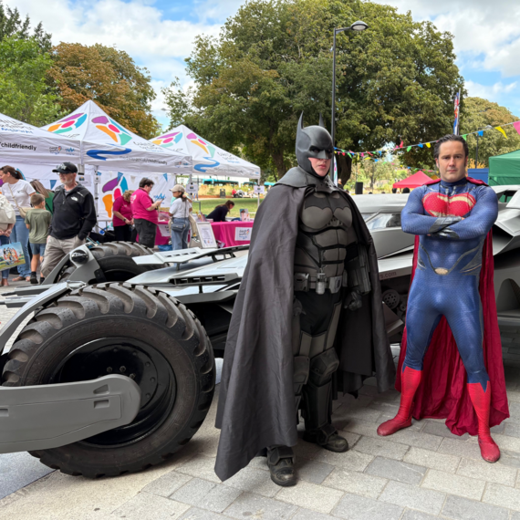 Batman and Superman with the Batmobile at the Super Saturday event