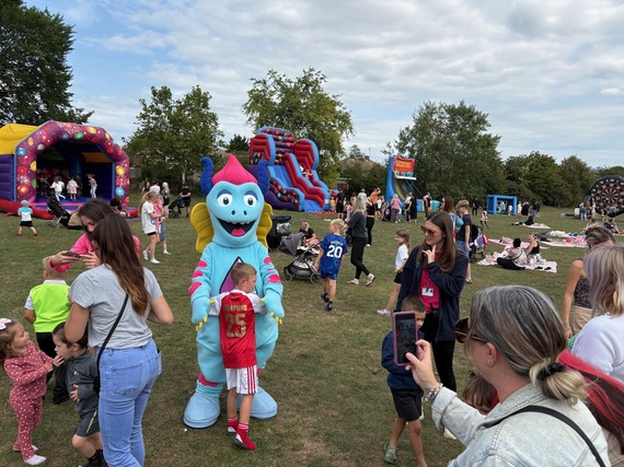 Children and young people meeting Mojo, our Child-Friendly Medway mascot at Hoo Family Fun Day