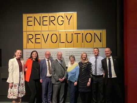 Met Office scientists in front of sign saying Energy Revolution