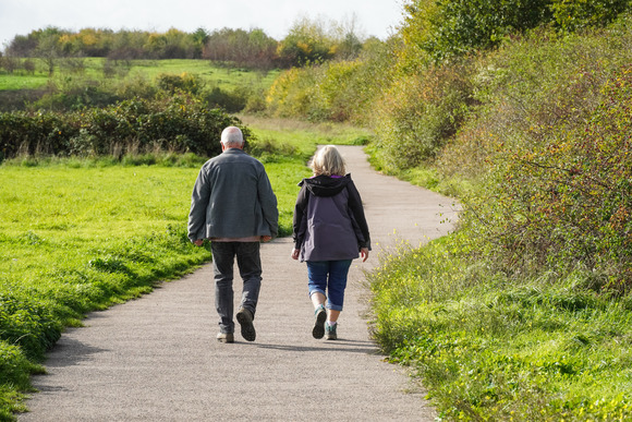 Man and woman walking down a path