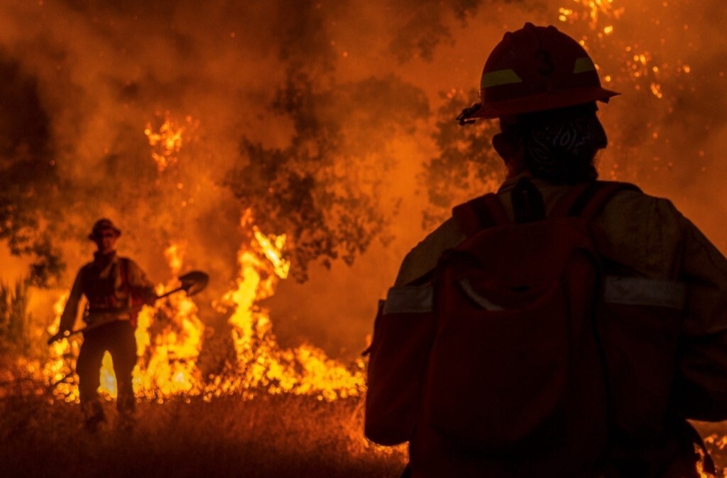 firemen in front of wildfire