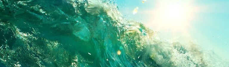 close-up of ocean wave reflecting sunshine
