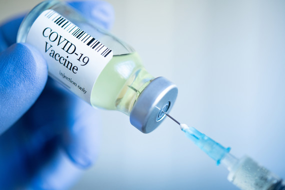 Stock image of someone preparing a COVID-19 vaccine