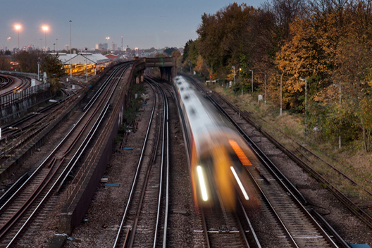Train moving at high speed and blurred on an indistinct railway line