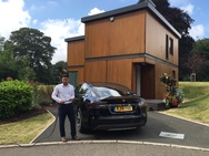 Vehicle with man on home driveway