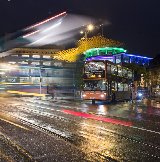 Buses at night with blurred lines showing movement