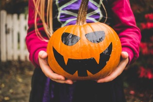 Halloween- young girl holding a pumpkin