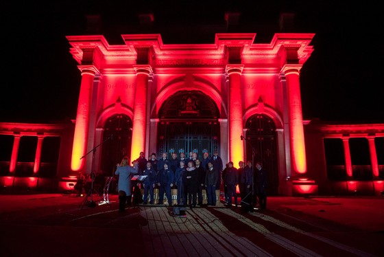 The Nottingham War Memorial at night lit up in red for Remembrance Day