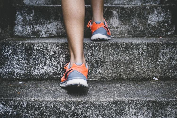 runner going up stone steps