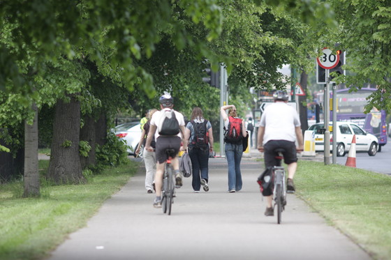 two cyclists riding away