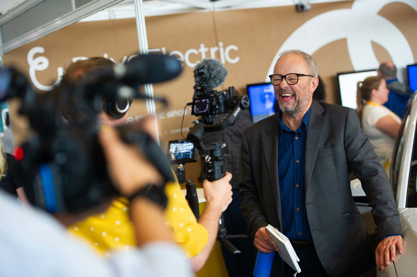 Robert Llewellyn from Fully Charged laughing in front of cameras 