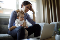 Mum with child sitting with computer