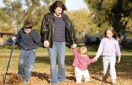 Woman and kids walking in the park