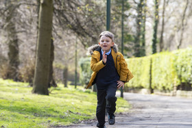 Child running through park