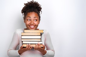 smiley person carrying lots of books