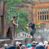 Open Air Theatre image of two men dressed up on stage with swords