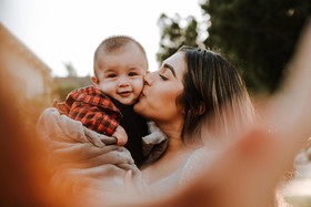 Woman kissing her baby