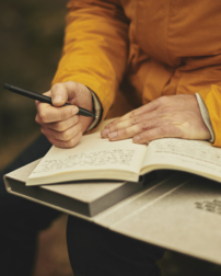 person writing in a book