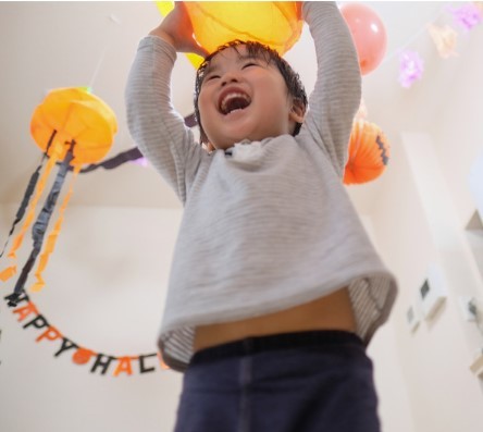 young child holding a lantern