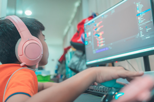 young person coding on a pc