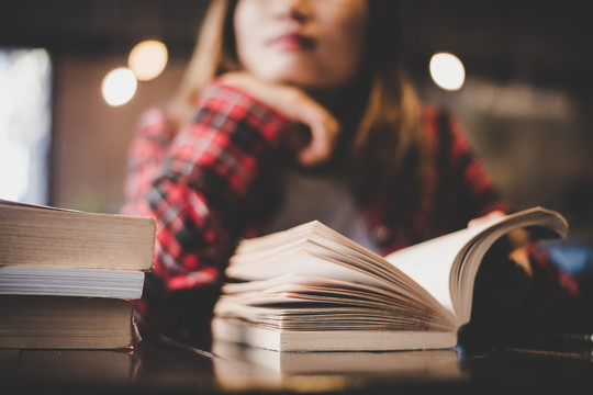 person in a library with open book