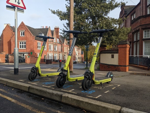 Three E-scooters parked