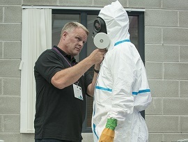 Member of the audience is helped into air-fed suit