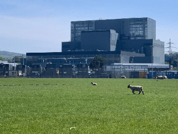 View of the Hunterston B power plant with green fields in front