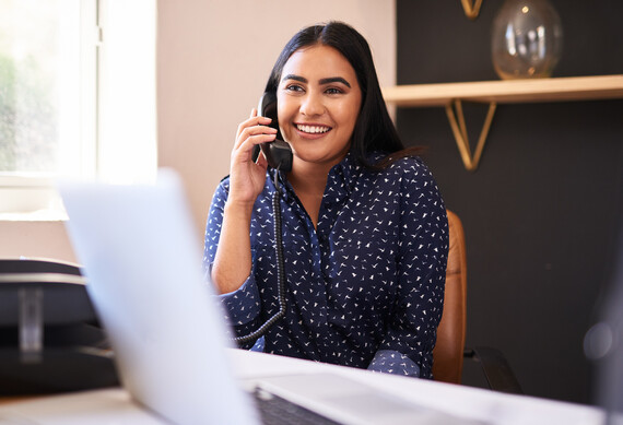 Lady on phone with laptop