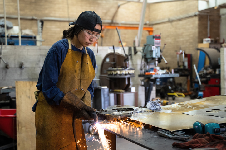 Woman welding in a workshop