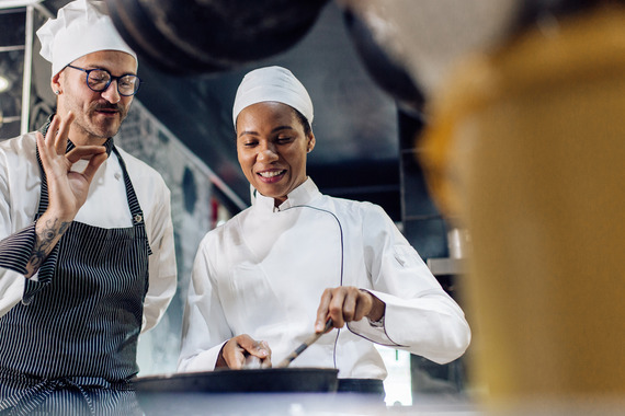 chef apprentice learning on the job, receiving praise for good work