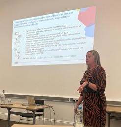 A lady presenting and look at the presentation