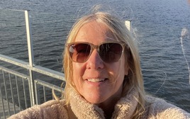 A female taking a self portrait with water in the background