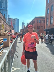 A man having completed a race and has a medal round his neck