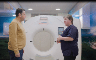 A man in front of a lung scanning machine