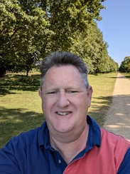A man taking a portrait photo at a park