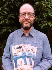A man holding three books 