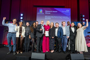 People on stage getting an Award