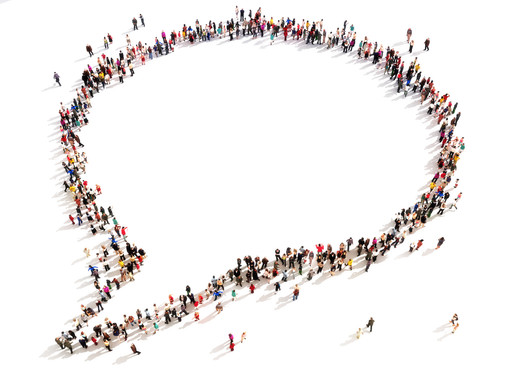 Birds eye view of lots of different people standing in a white space. Together they form one large speech bubble. 