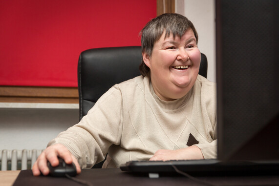 Woman sitting at a desk and staring at a computer