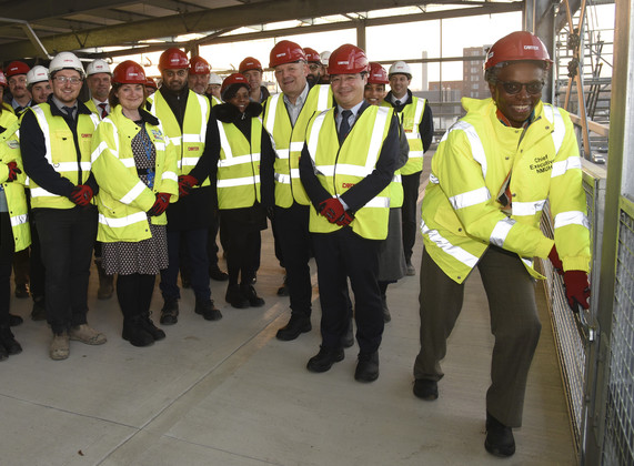 Nnenna tightening bolt at topping out ceremony