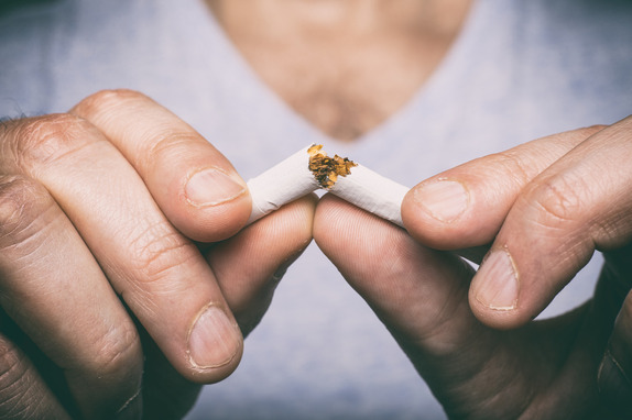Image of male hand crushing cigarette